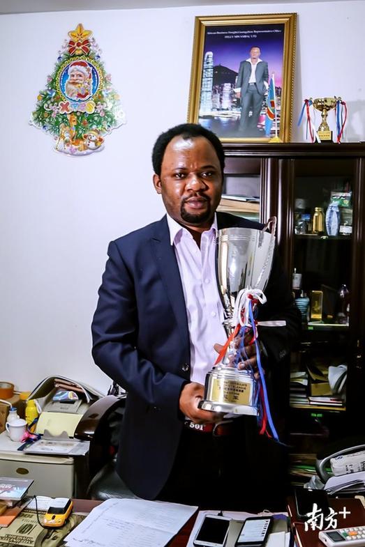 飞利手捧2015年广州“领馆杯”足球联赛的冠军奖杯。